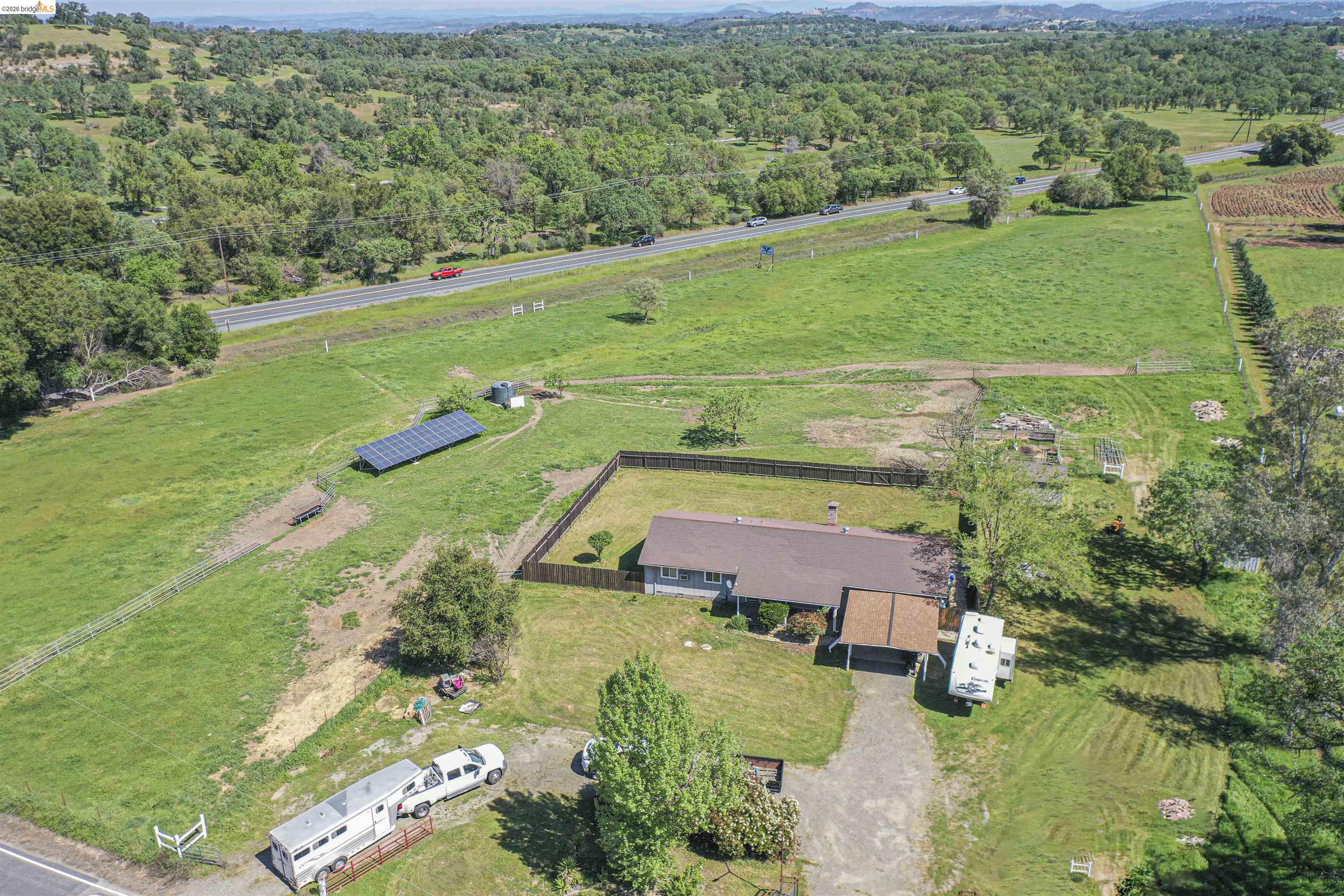 10458 Southworth Road Valley Springs, CA 95252 - Photo 3 of 22 Aerial view of sparsely populated area with agricultural land and large plots for crops