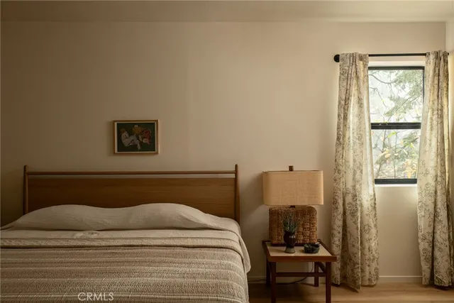 a bedroom with a bed and a window