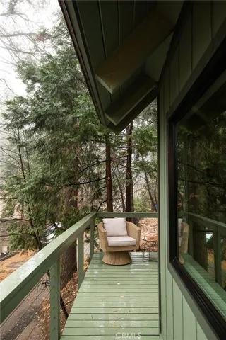 a balcony with wooden floor and outdoor space