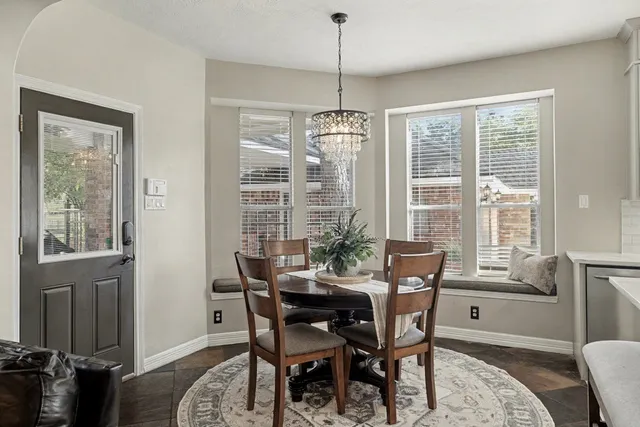 a bedroom with a large bed and a chandelier fan