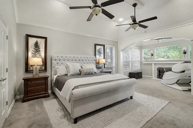a living room with furniture a fireplace and windows