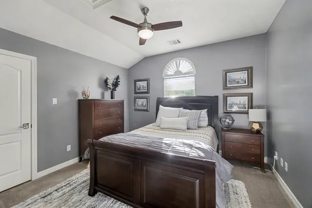 a bedroom with a bed and a book shelf