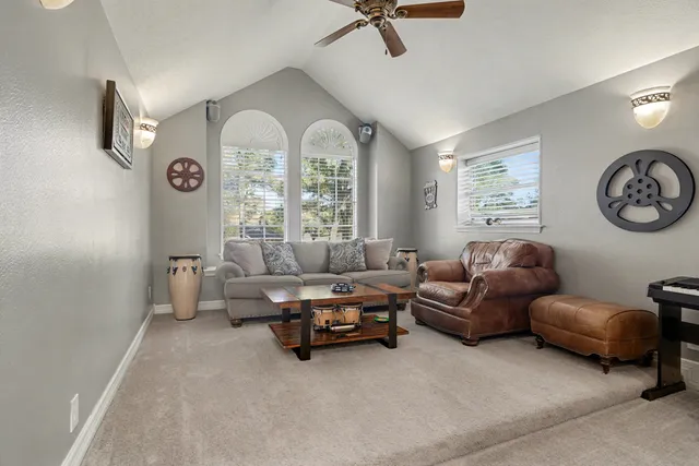 a living room with furniture a flat screen tv and a window