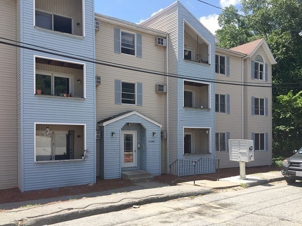 7 Gibbs Street, Unit 9 Worcester, MA 01607 - Photo 1 of 11 a front view of a house with a yard and garage