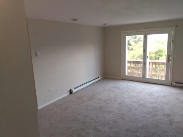 a view of an empty room with a window