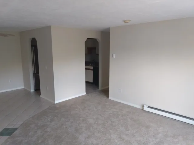 an empty room with closet and bathroom