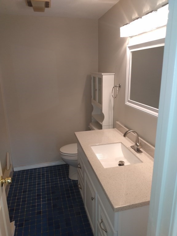 7 Gibbs Street, Unit 9 Worcester, MA 01607 - Photo 7 of 11 a bathroom with a sink toilet and mirror