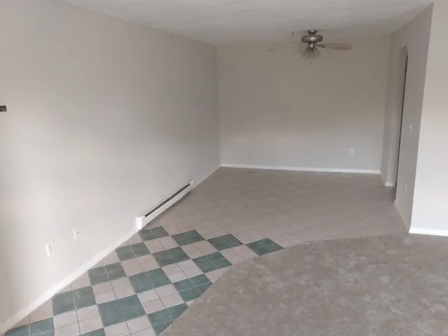 a view of a closet with white walls