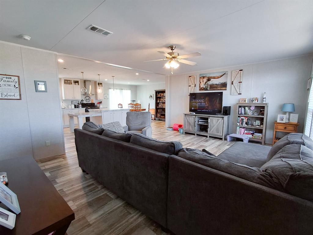 7256 Johnson Road Granbury, TX 76049 - Photo 11 of 40 Living area featuring wood finished floors and a ceiling fan