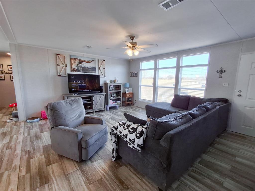 7256 Johnson Road Granbury, TX 76049 - Photo 12 of 40 Living room featuring wood finished floors and ceiling fan