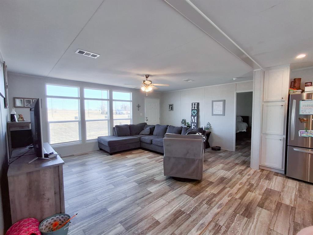 7256 Johnson Road Granbury, TX 76049 - Photo 13 of 40 Living room featuring light wood-type flooring and ceiling fan