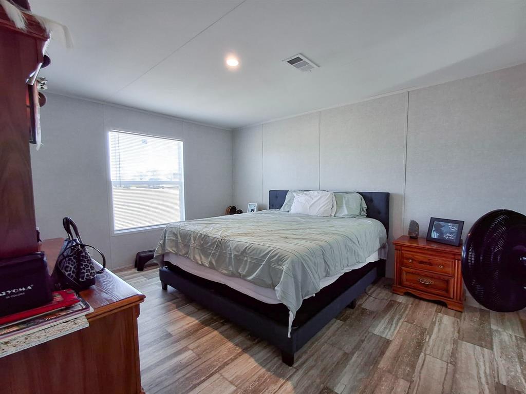 7256 Johnson Road Granbury, TX 76049 - Photo 24 of 40 Bedroom featuring wood finished floors and recessed lighting