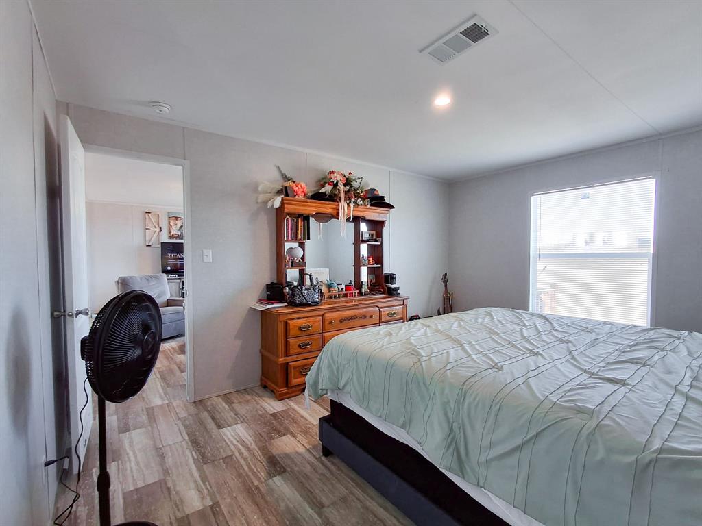 7256 Johnson Road Granbury, TX 76049 - Photo 26 of 40 Bedroom with light wood-style flooring and recessed lighting