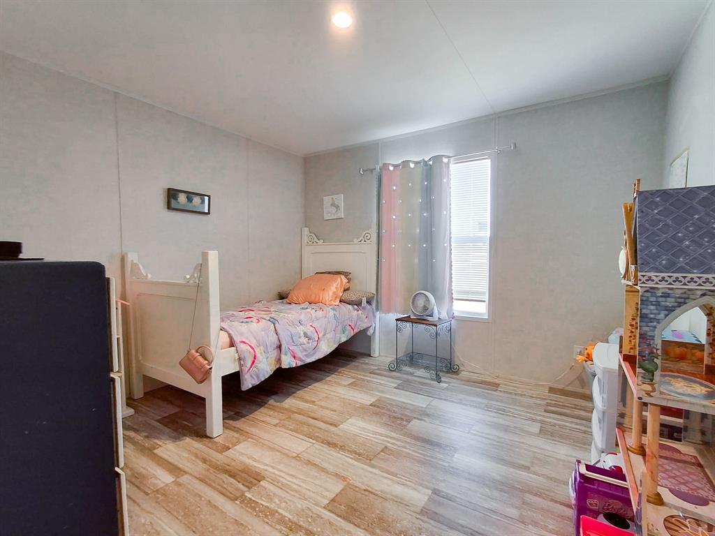 7256 Johnson Road Granbury, TX 76049 - Photo 30 of 40 Bedroom featuring light wood-style flooring