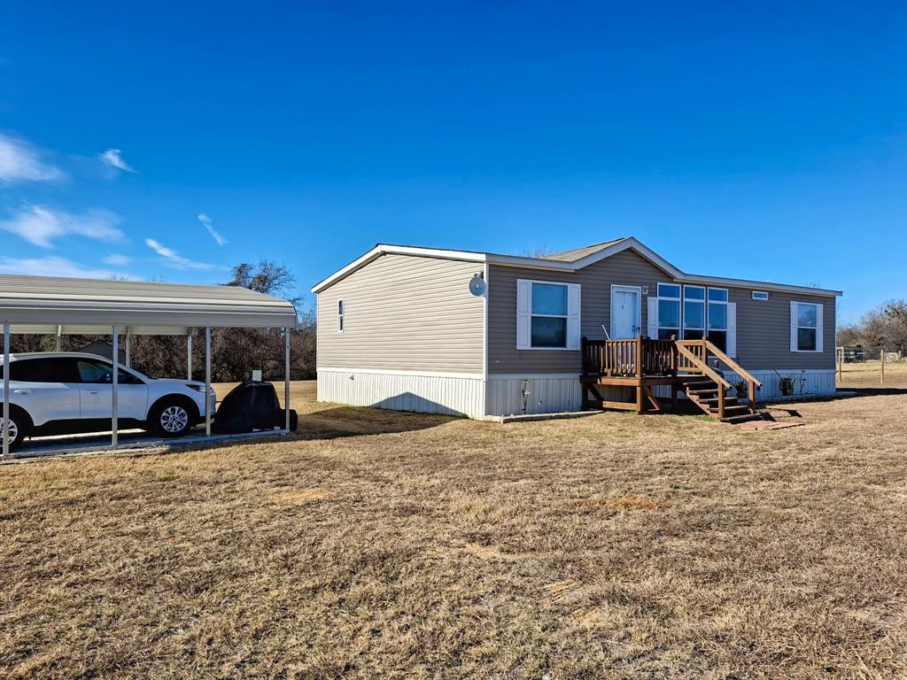 7256 Johnson Road Granbury, TX 76049 - Photo 3 of 40 Rear view of property featuring a yard