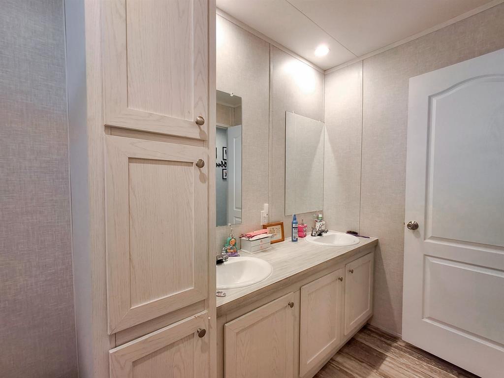 7256 Johnson Road Granbury, TX 76049 - Photo 33 of 40 Full bath featuring double vanity and light wood finished floors