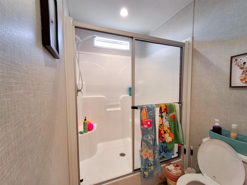 7256 Johnson Road Granbury, TX 76049 - Photo 34 of 40 Full bathroom featuring a stall shower and toilet