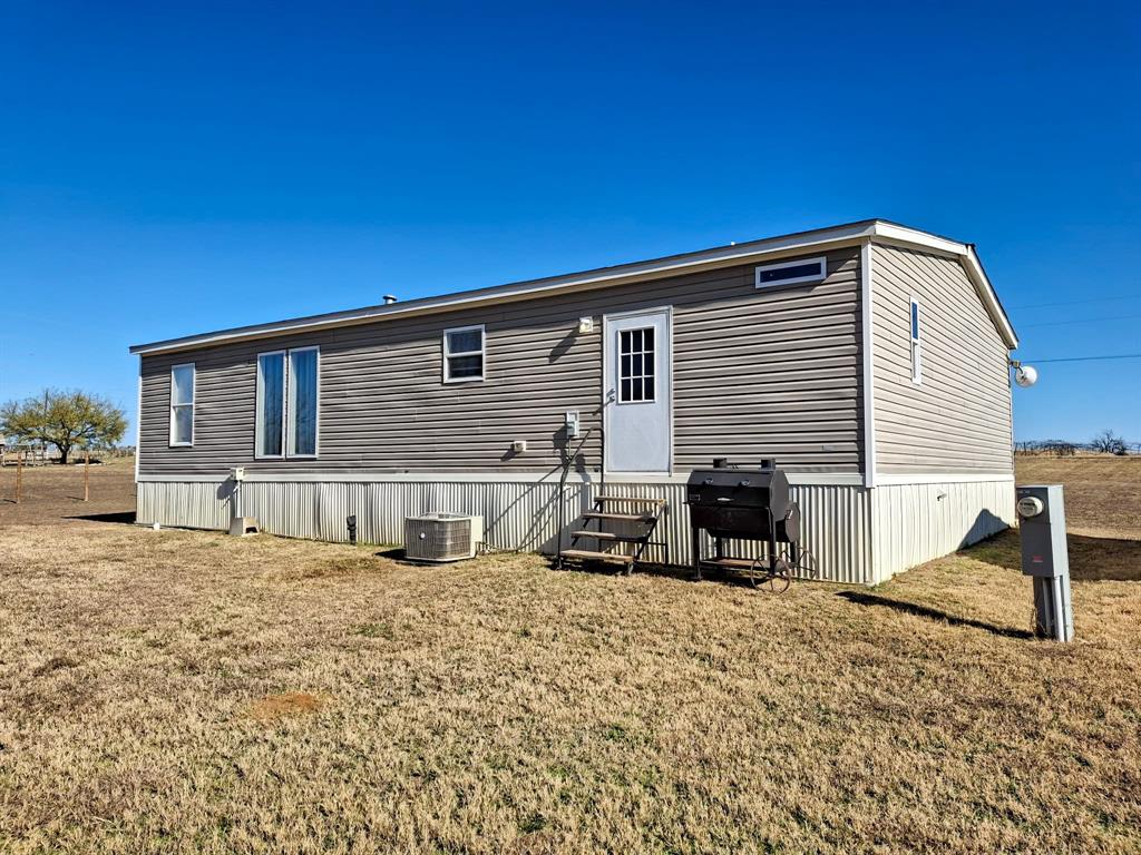 7256 Johnson Road Granbury, TX 76049 - Photo 37 of 40 Rear view of property featuring a lawn