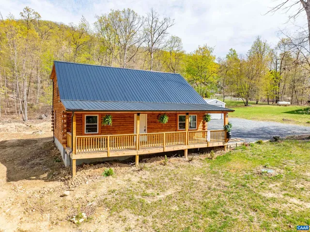 a view of a house with a yard and wooden fence