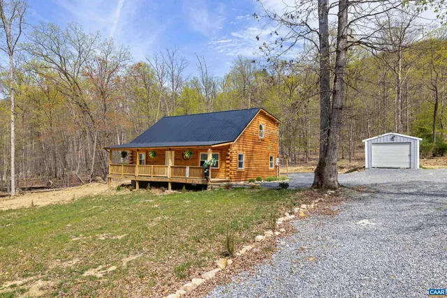 a view of empty room with wooden floor and floor to ceiling window