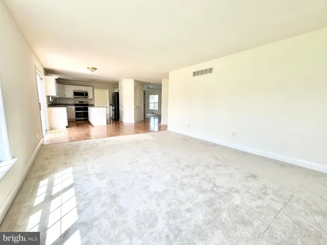 a view of a kitchen with cabinets and wooden floor