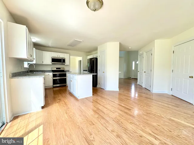 a view of kitchen view with wooden floor and electronic appliances