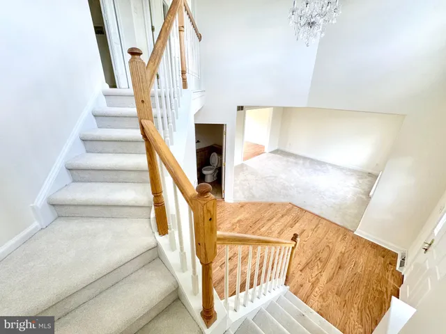 a view of staircase with white walls and windows