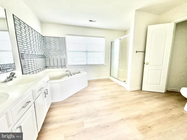 a bathroom with a glass shower door