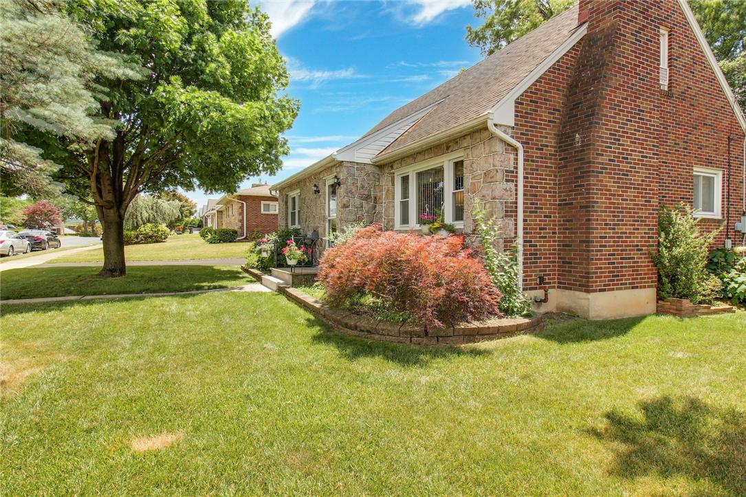 1256 Ridge Avenue Whitehall, PA 18052 - Photo 5 of 43 A classic brick and stone facade welcomes guests to this charming residence with a well-maintained lawn.