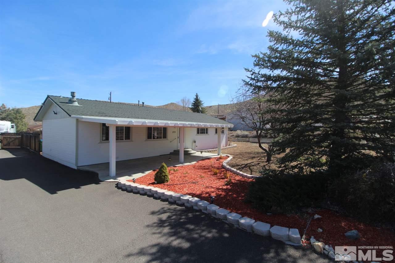 8715 Aquifer Way Reno, NV 89506 - Photo 1 of 18 a front view of a house with a yard