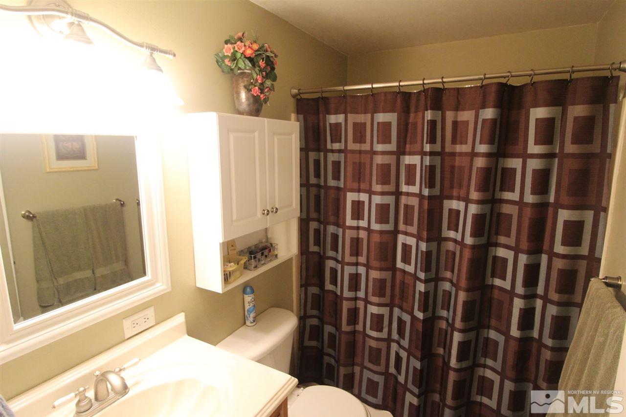 8715 Aquifer Way Reno, NV 89506 - Photo 12 of 18 a bathroom with a shower toilet and sink