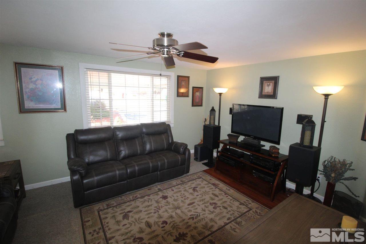 8715 Aquifer Way Reno, NV 89506 - Photo 4 of 18 a living room with furniture and a flat screen tv