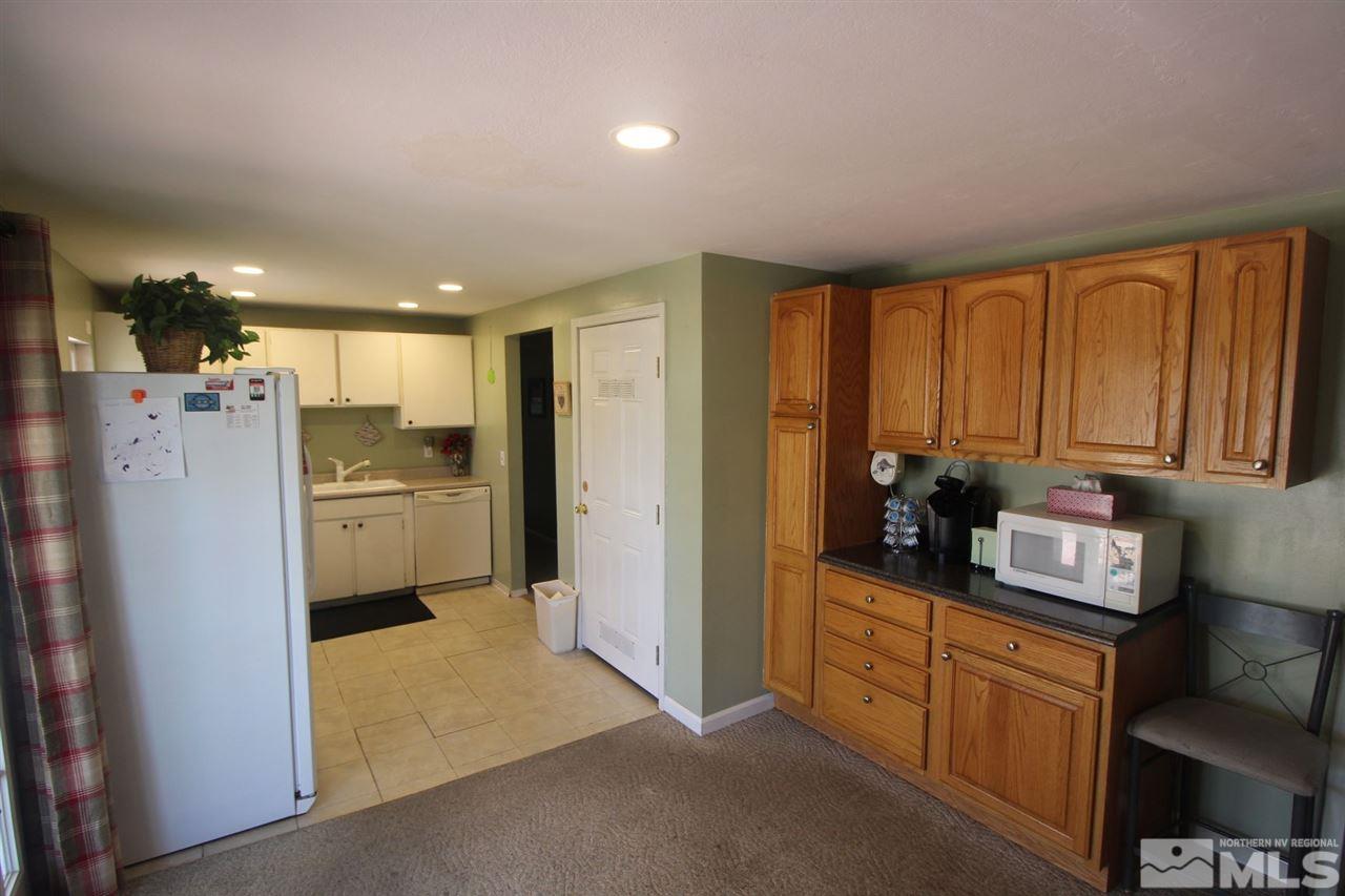 8715 Aquifer Way Reno, NV 89506 - Photo 7 of 18 a kitchen with refrigerator cabinets and furniture