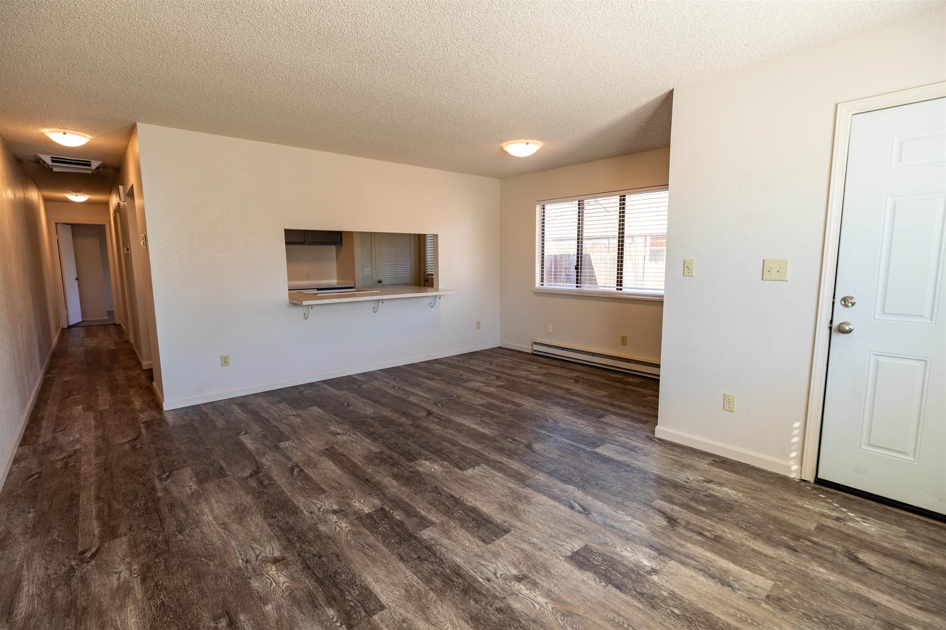 239 South Elm Street, Unit A Fruita, CO 81521 - Photo 3 of 22 an empty room with wooden floor and windows