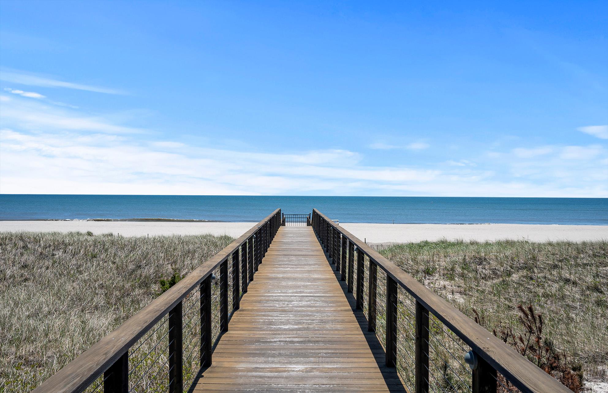 View of home's community with view of water and beach