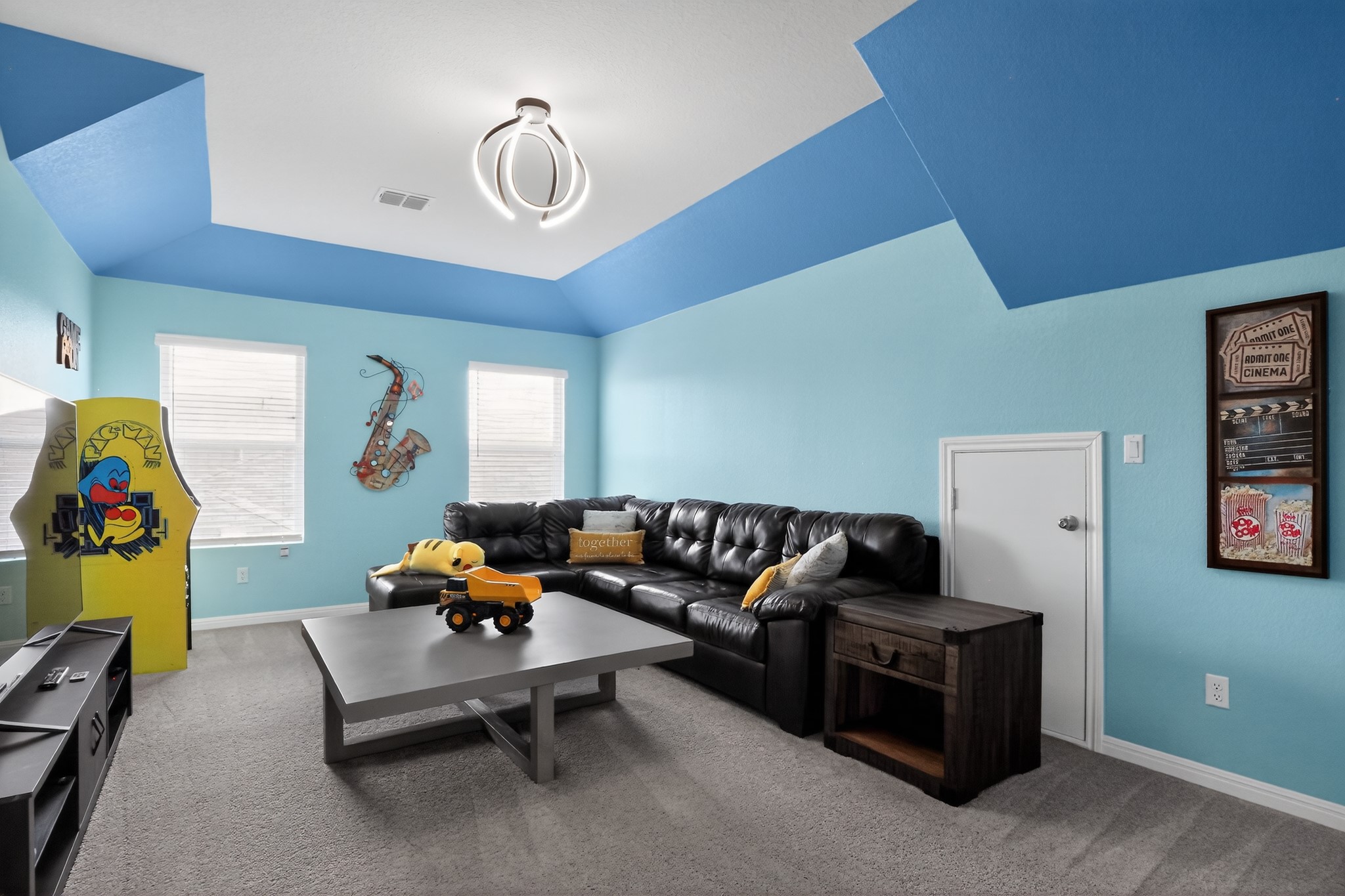 114 Bosco Road Hutto, TX 78634 - Photo 17 of 39 A vibrant room featuring vaulted ceilings and soft carpet underfoot.