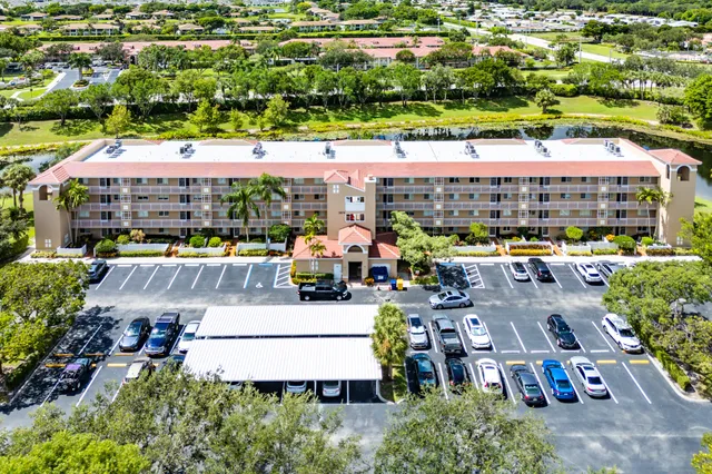 an aerial view of a house with a swimming pool and lake view