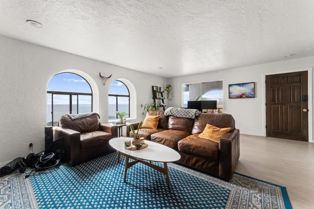 a kitchen with white cabinets and sink