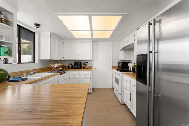 a bed sitting in a bedroom and a large window