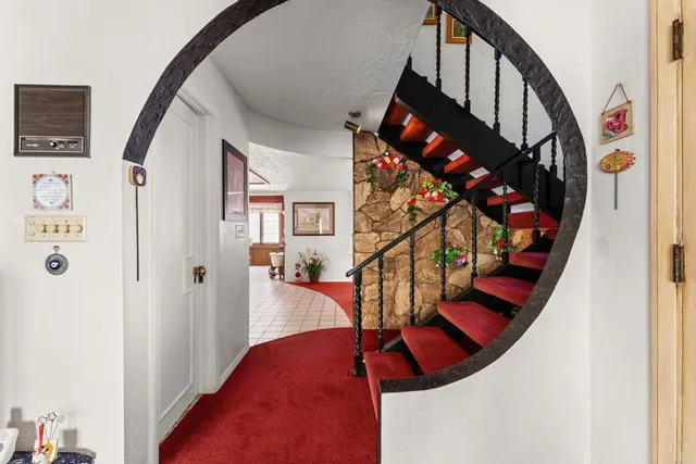 a living room with furniture kitchen view and a large window