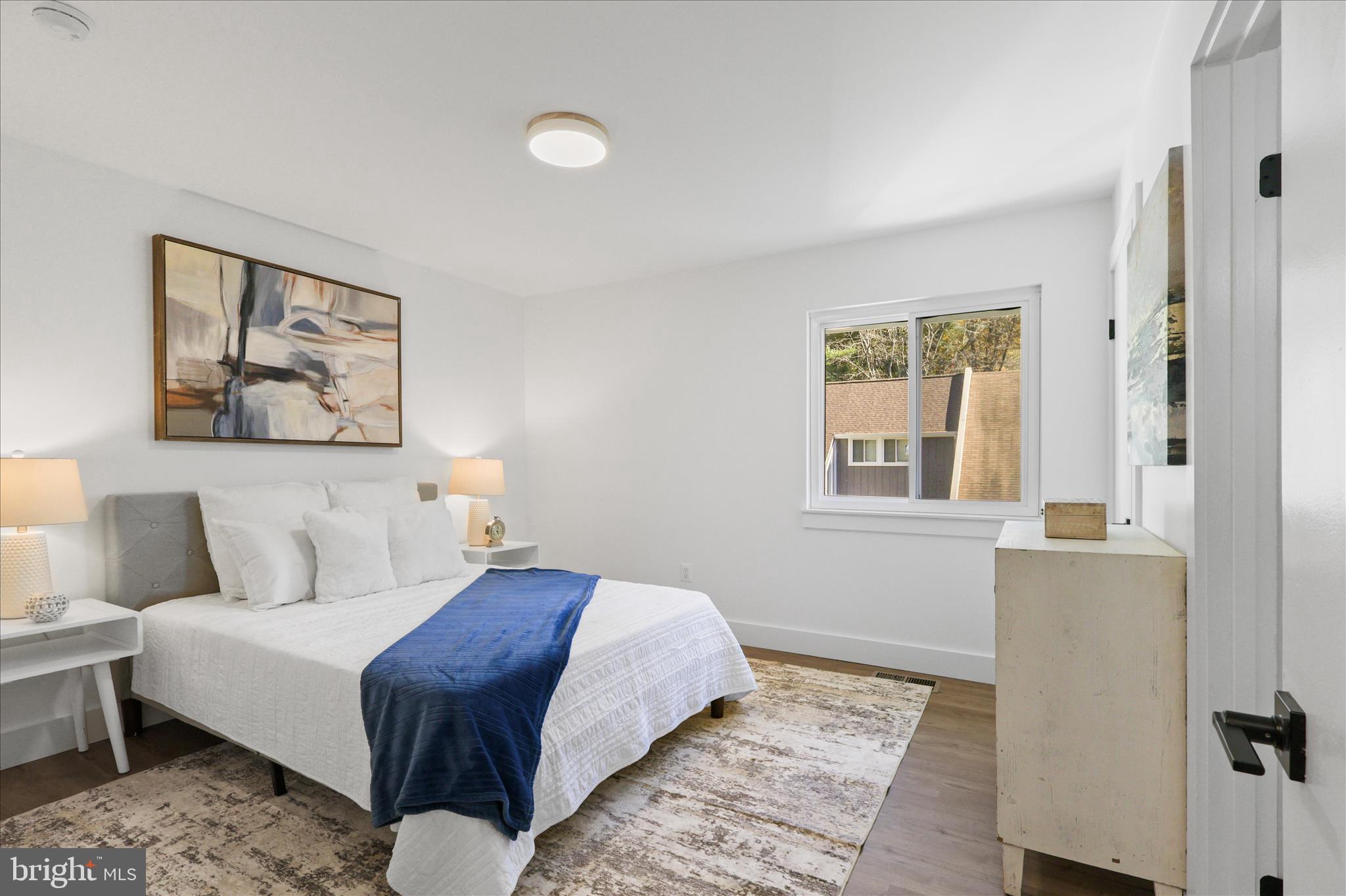 11152 Forest Edge Drive Reston, VA 20190 - Photo 18 of 57 a bedroom with a bed and a painting on the wall