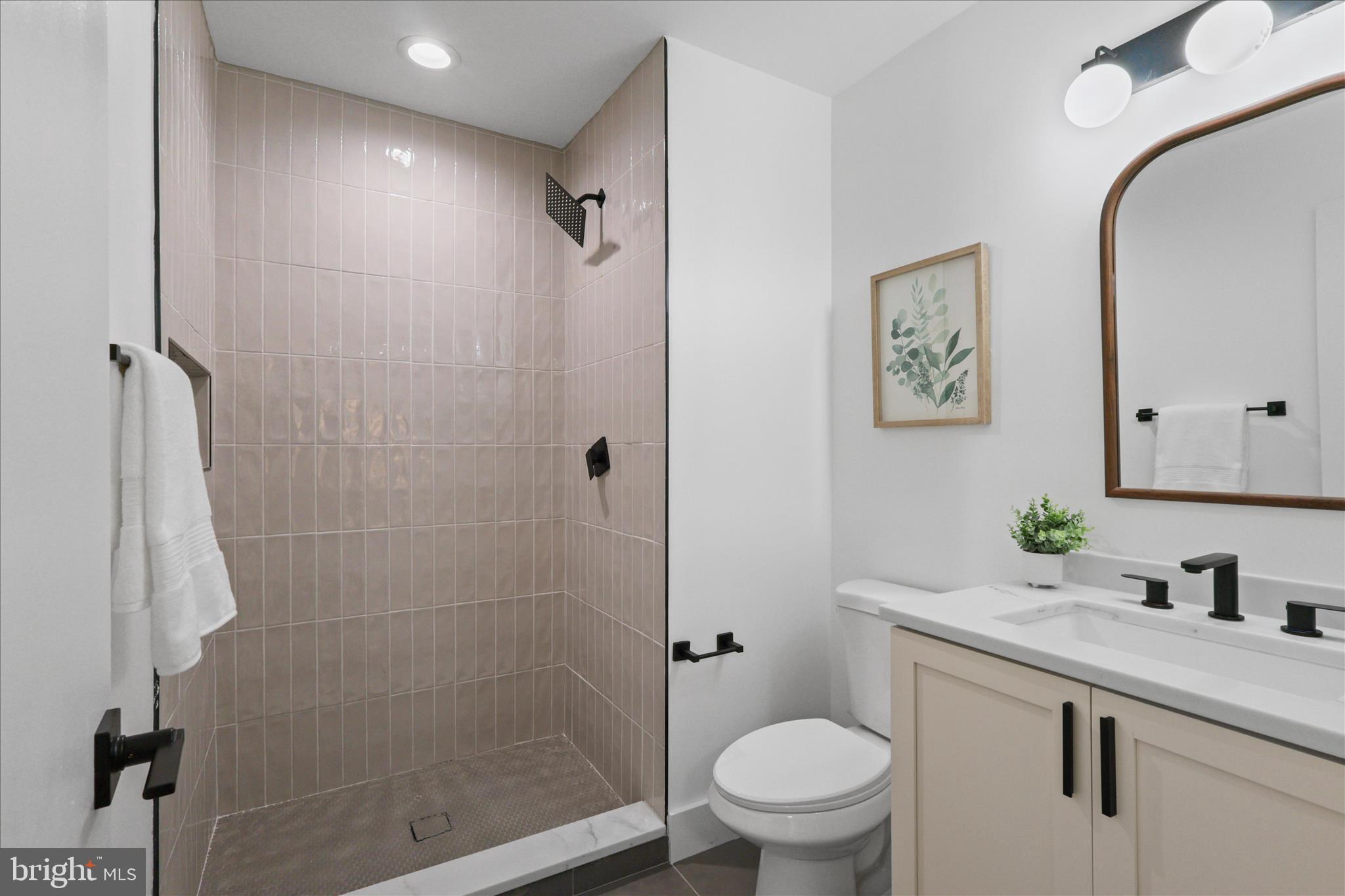 11152 Forest Edge Drive Reston, VA 20190 - Photo 22 of 57 a bathroom with a granite countertop sink toilet and shower