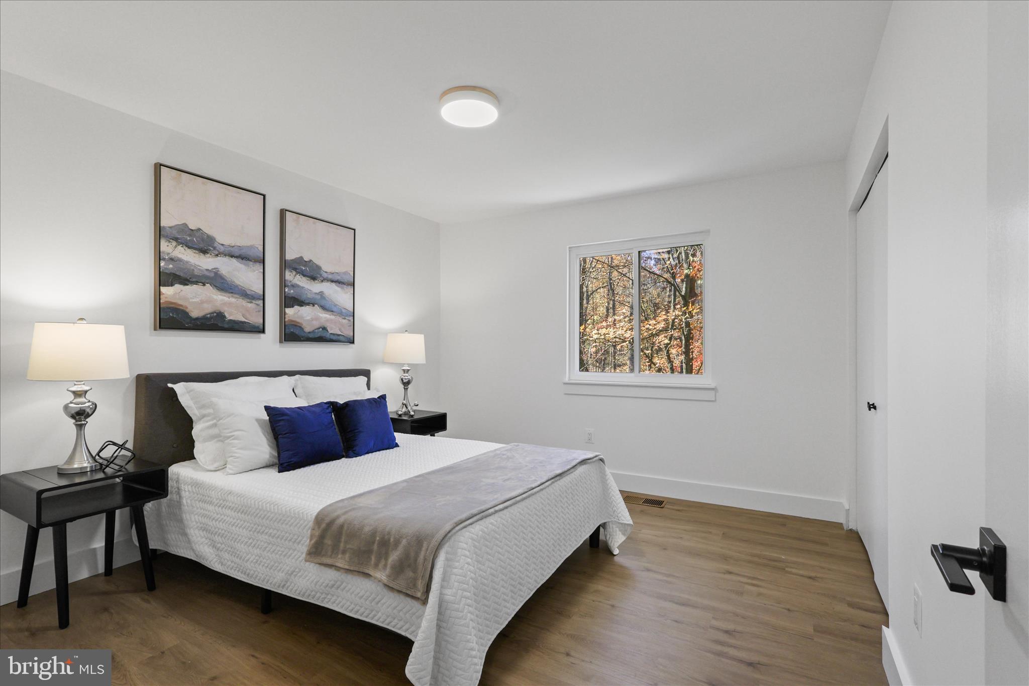 11152 Forest Edge Drive Reston, VA 20190 - Photo 23 of 57 a bedroom with a large bed and a painting on the wall