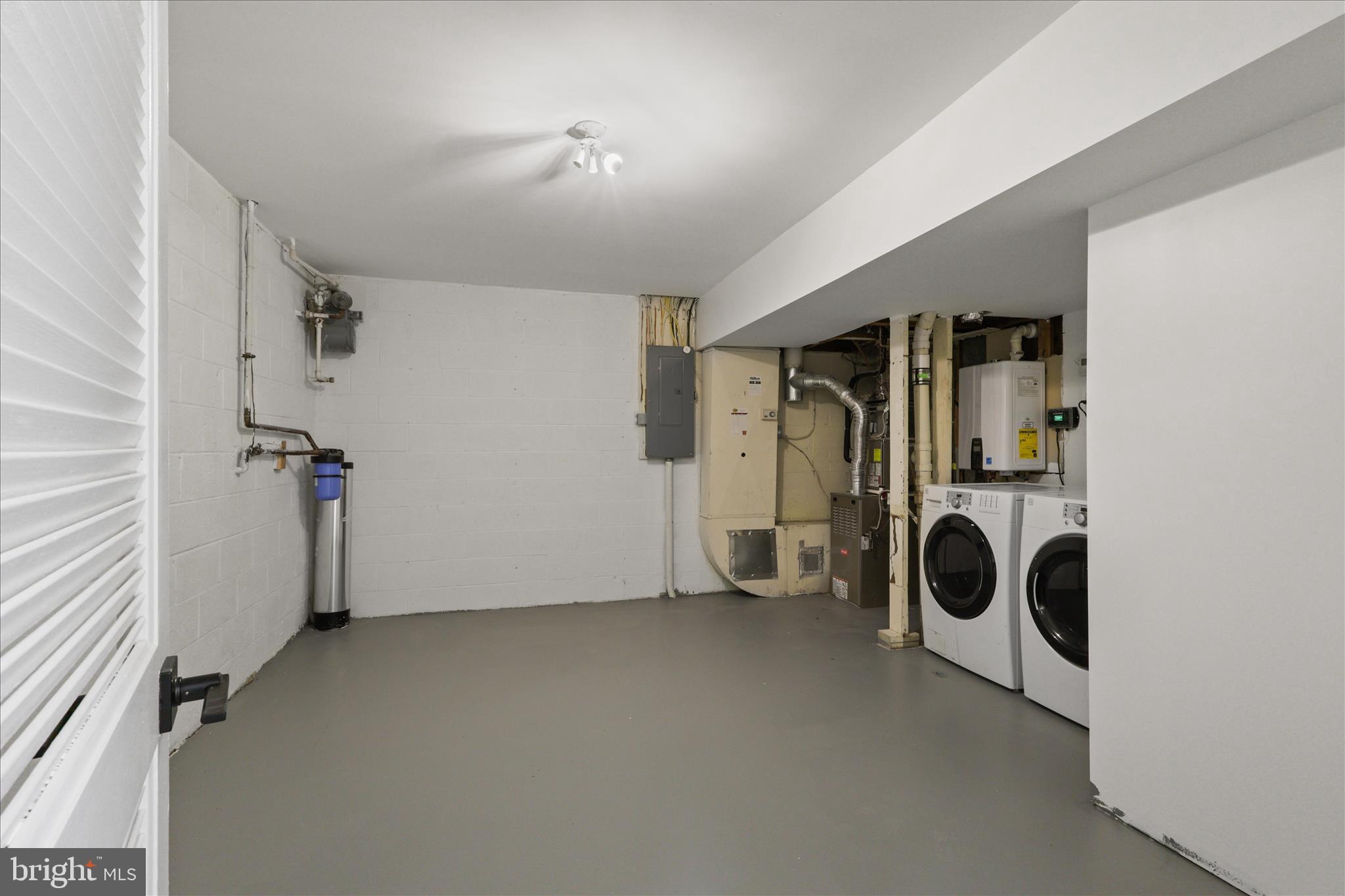 11152 Forest Edge Drive Reston, VA 20190 - Photo 27 of 57 a view of a storage & utility room with two washing machine