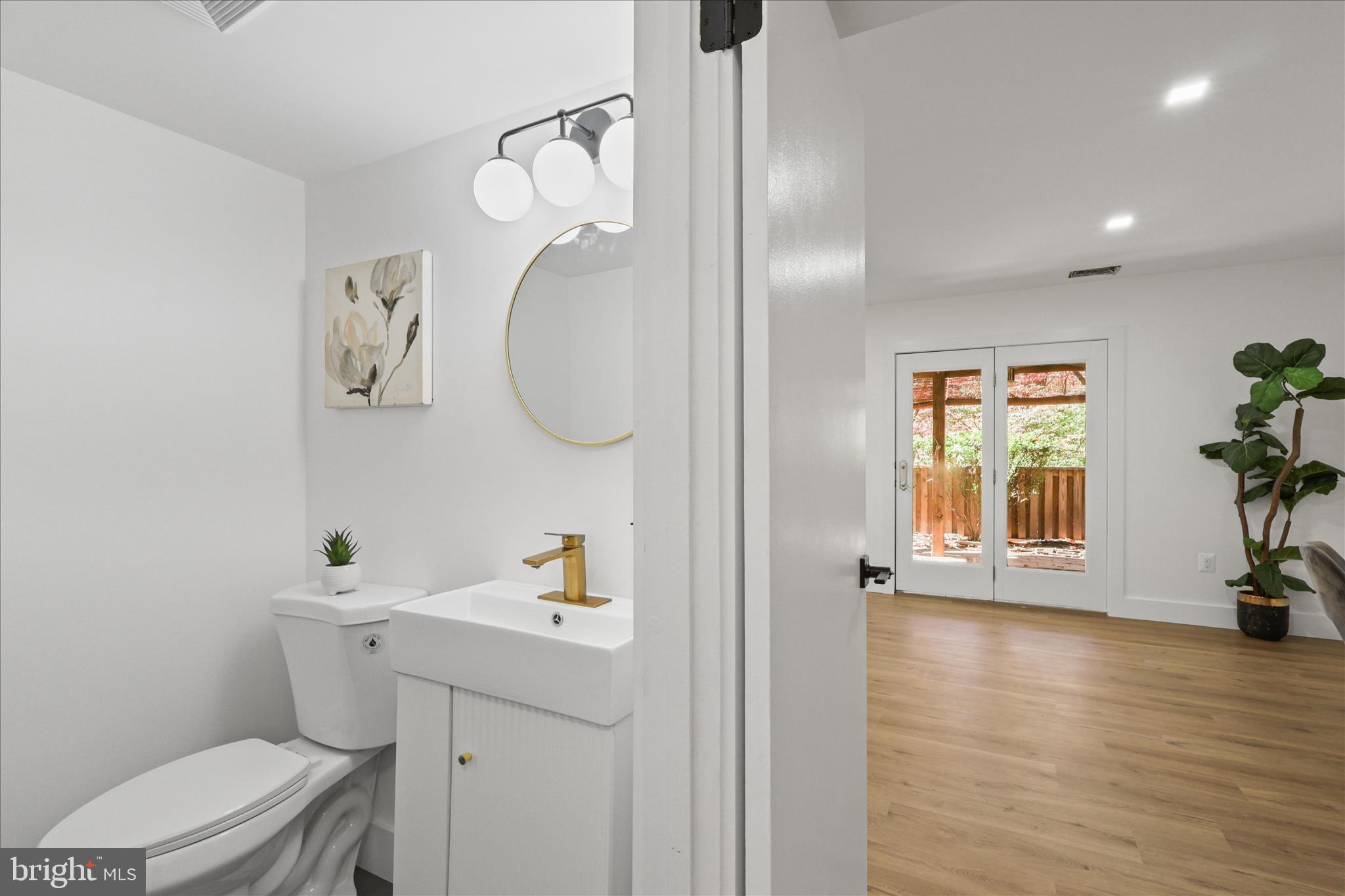 11152 Forest Edge Drive Reston, VA 20190 - Photo 28 of 57 a bathroom with a toilet a sink and a mirror