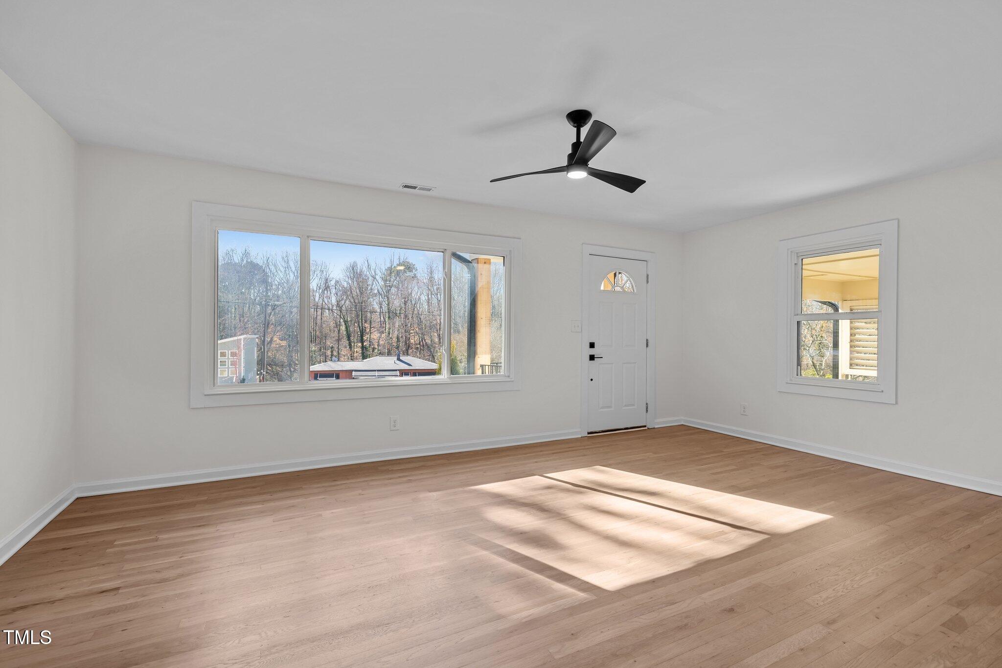 1805 Pritchard Place Durham, NC 27707 - Photo 11 of 46 a view of an empty room with wooden floor and a window