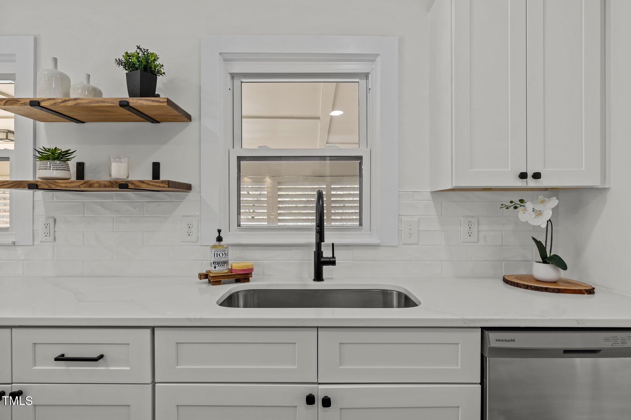 1805 Pritchard Place Durham, NC 27707 - Photo 18 of 46 a kitchen with stainless steel appliances white cabinets and a sink