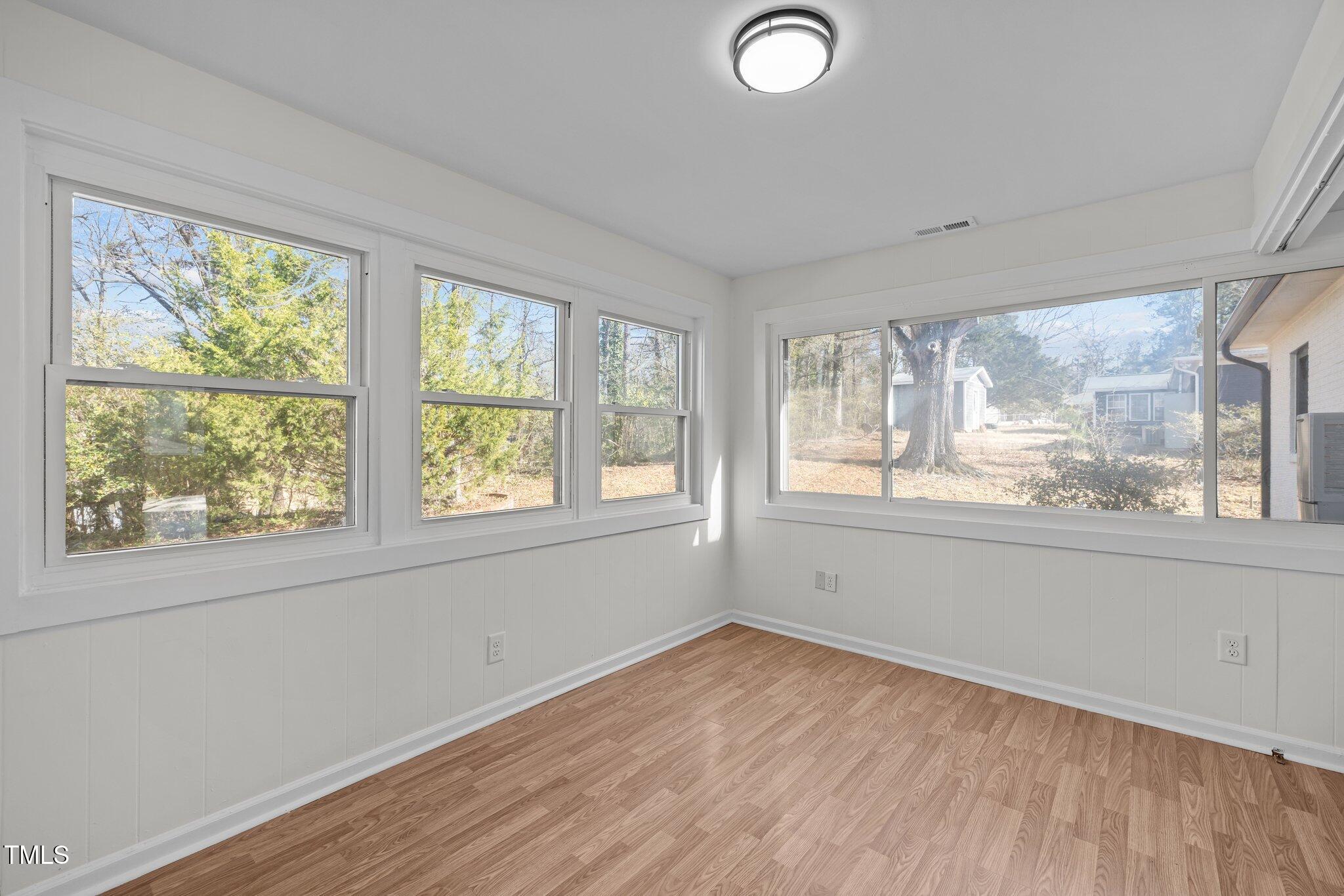 1805 Pritchard Place Durham, NC 27707 - Photo 21 of 46 a view of empty room with wooden floor and fan