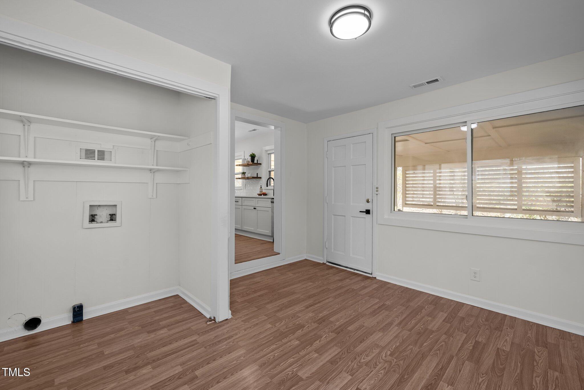 1805 Pritchard Place Durham, NC 27707 - Photo 23 of 46 an empty room with wooden floor and windows