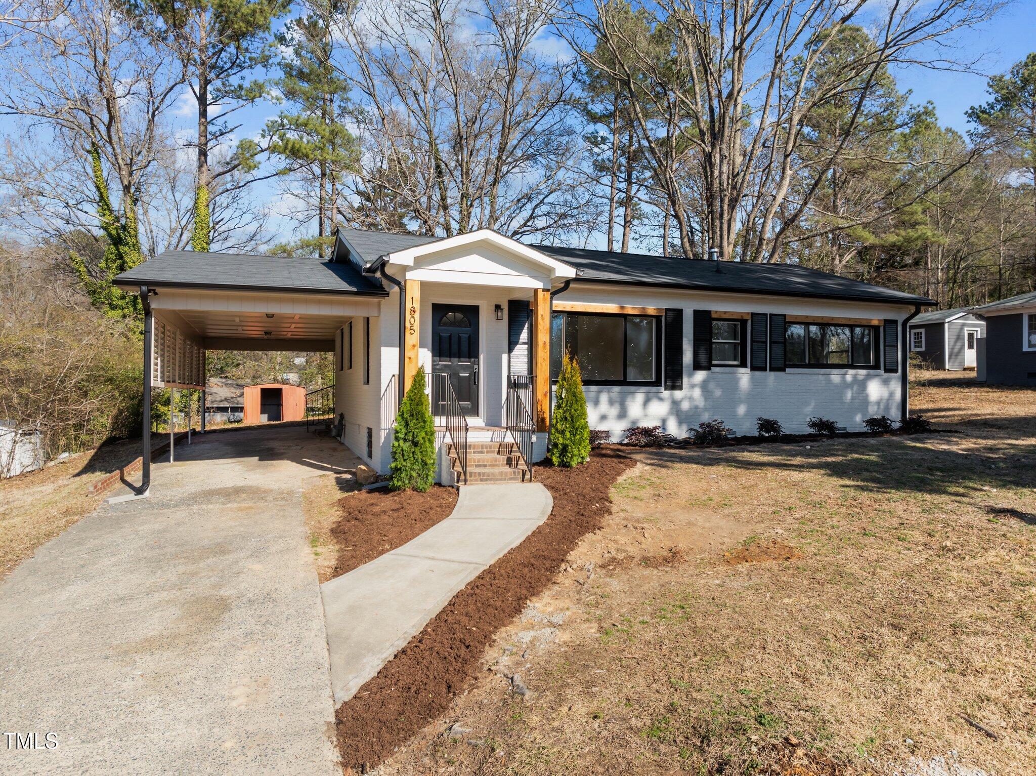 1805 Pritchard Place Durham, NC 27707 - Photo 2 of 46 a view of a house with a barbeque and large trees